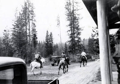 Jimmy Rice, on white mule, Joe Gray, going to a fire. Others unidentified.