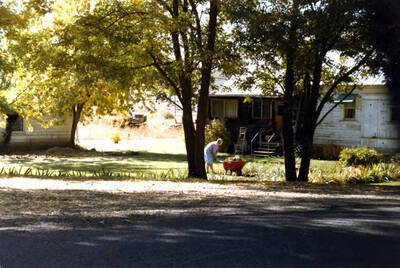 View of lady doing yard work. Midvale, Idaho.