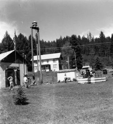 People stand outside, looking at something, during Bovill's Statehood Day celebration.