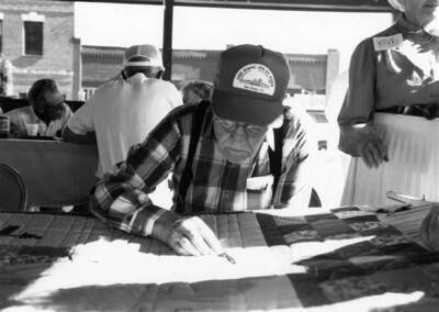 A man works on a quilt during Bovill's Statehood Day celebration.