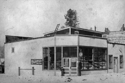 Peter Johnson and his son standing outside his store.