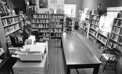 Women put away books in the Bovill Library when it was co-shared with City Hall.