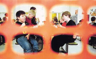 Students eating lunch in the Bovill gymnasium and cafeteria. Tim Nelson is pictured in all black on the right