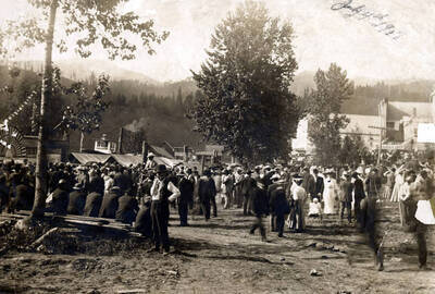 Boat excursions up the St. Joe River. Crowd of people on bank. Boat 'Idaho' at left, boat 'The Spokane' in center. Ferrel, Idaho.