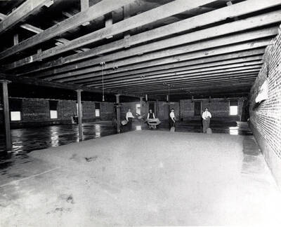Barley being spread to dry on floor of large room. C. Weisgerber Brewery. Lewiston, Idaho.