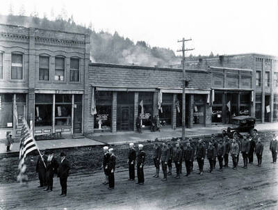 Man holding U.S. flag is Mr. Weaver, a Civil War veteran