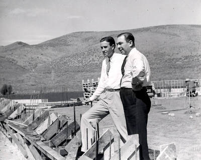 Averell Harriman, founder, and Steve Hannagan, original publicity man, looking at lodge construction. Sun Valley, Idaho.