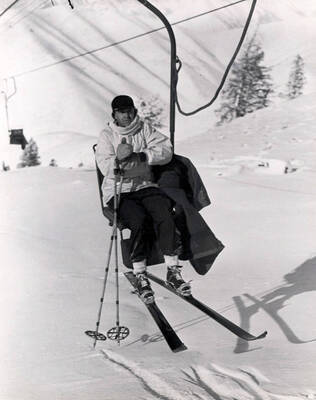 Averell Harriman, founder of Sun Valley, riding Proctor Mountain chairlift. Sun Valley, Idaho.