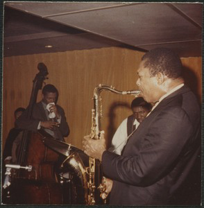 John Coltrane (saxophone), Elvin Jones (drums), and Jimmy Garrison (double bass) performing at the Jazz Workshop from a series of photographs of jazz musicians taken by jazz aficionado and supporter, Bernie Moss.