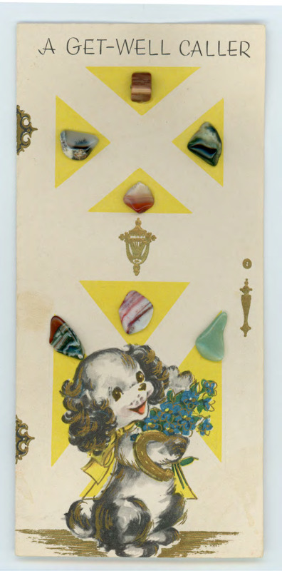 Greeting card from the Kilbarn family. Front: art of a dog holding flowers with several small stones glued to the front. Inside: a handwritten note wishing Crabtree better health after his accident.