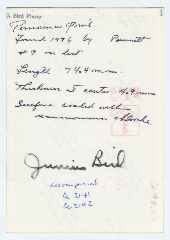 The front of a lithic point from Panama. The back of the photo describes its length as 4.4mm and its thickness at its center as 4.9mm. It is signed by Junius Bird.