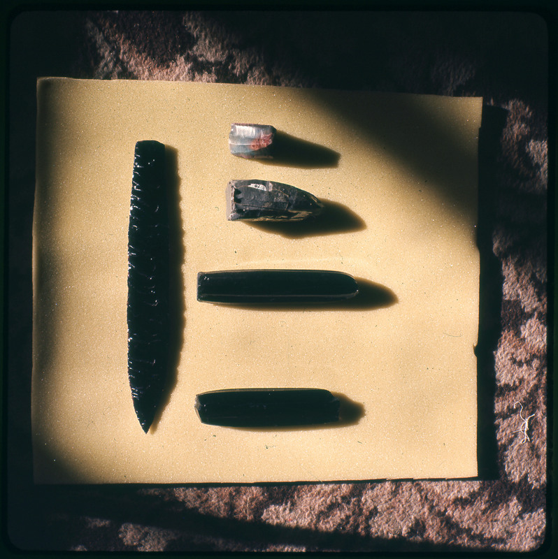 A photographic slide of a series of lithic cores and a lithic point.