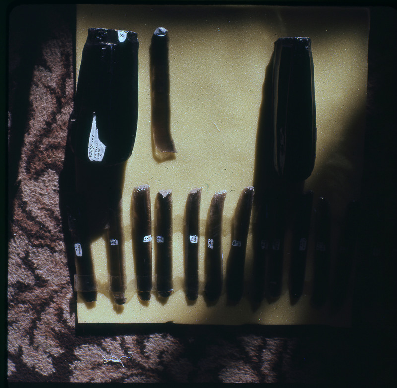 A photographic slide of a series of obsidian cores and the blades struck from them.