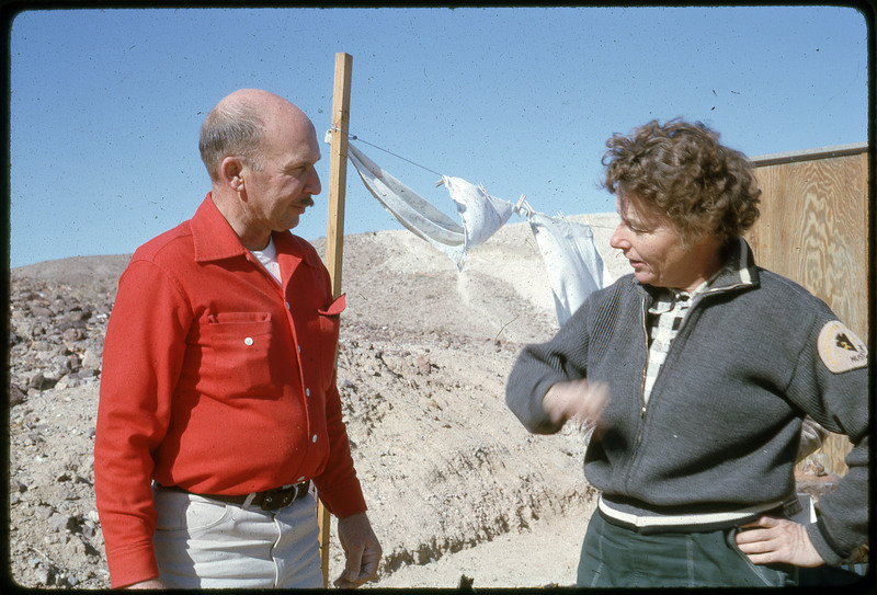 A photographic slide of a man and a woman speaking at a lithic sourcing site.