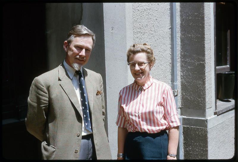 A photographic slide of a man and a woman smiling in front of a building.