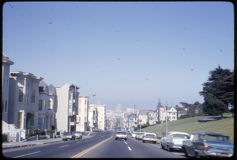 A photographic slide of a road extending through a series of apartments.