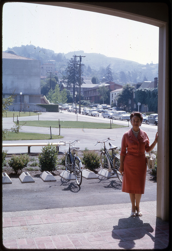 A photographic slide of Evelyn Crabtree standing in front of a busy road.