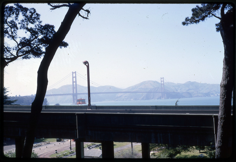 A photographic slide of a scenic view of a bridge over a large body of water.