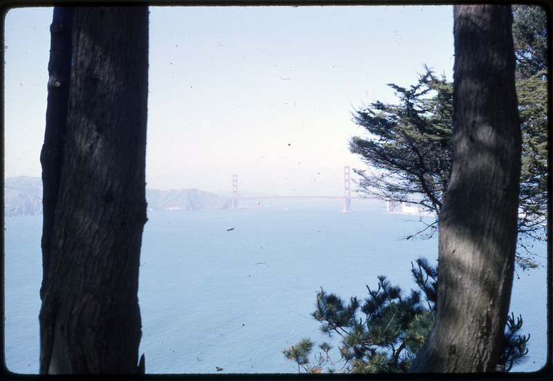 A photographic slide of a scenic view of a bridge over a large body of water.