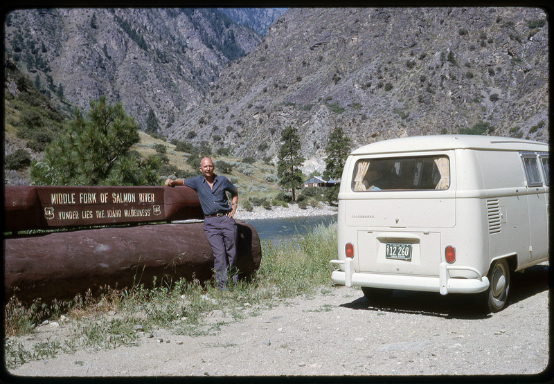 A photographic slide of Don E. Crabtree standing next to a van in front of the middle fork of the Salmon River.