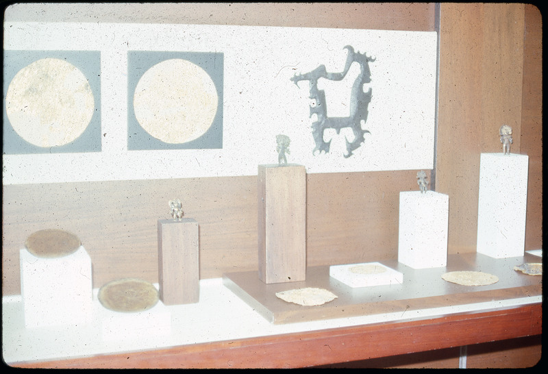 A photographic slide of a grainy view of a display of lithic artifacts.