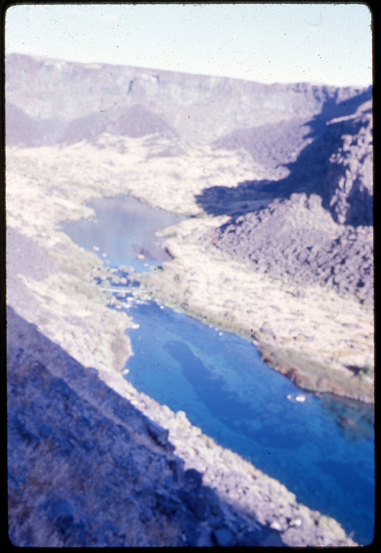 A photographic slide of a blurry view of a river from above.