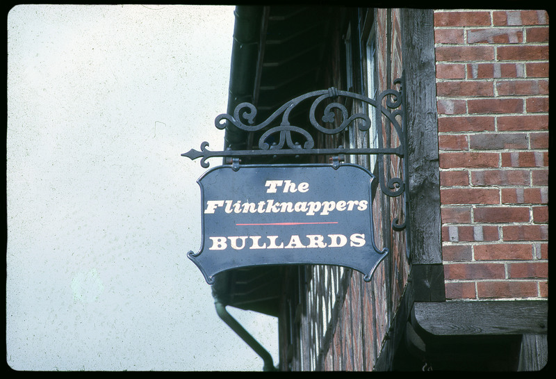 A photographic slide of a sign on the side of a building that reads "The Flintknappers Bullards".