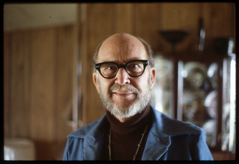 A photographic slide of Donald Crabtree smiling. He is wearing glasses and a nice suit.