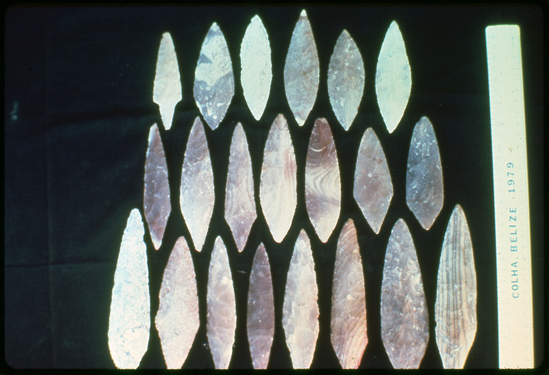 A photographic slide of lithic tools and bifaces arranged in a pyramid format. They are from Colha, Belize in 1979.