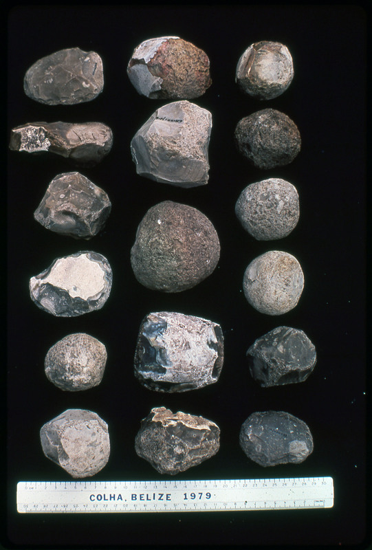 A photographic slide of an arrangement of hammerstones above a ruler. They are from Colha, Belize, 1979.