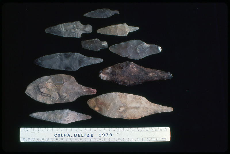 A photographic slide of arrowheads arranged on a black surface. They are from Colha, Belize in 1979.