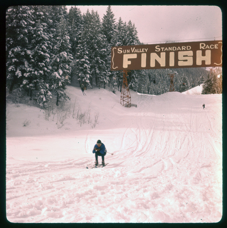 A photographic slide of a person skiing past the Sun Valley Standard race finish line.