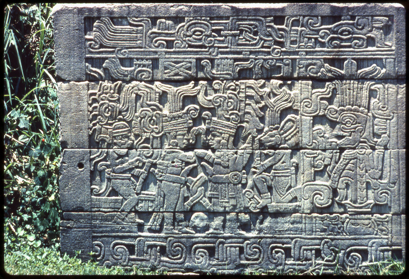 A photographic slide of a stone carving of a pattern of people. Likely a mesoamerican carving.