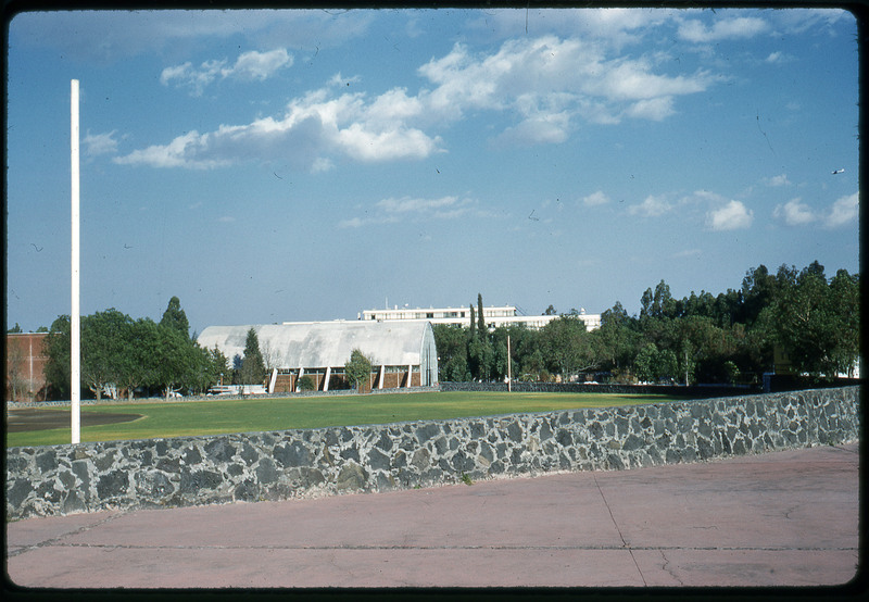 A photographic slide of an urban campus with geometric buildings.