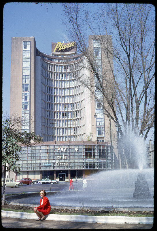 A photographic slide of Evelyn Crabtree standing in front of the Paz en la Tierre Plaza.