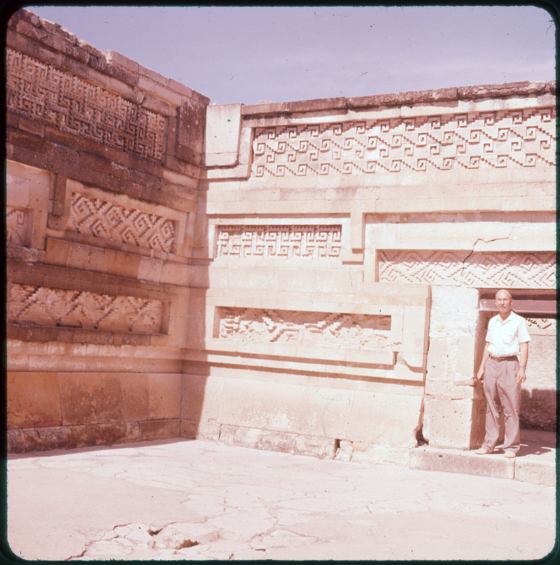 A photographic slide of stone walls without a ceiling. The walls have geometrics carvings in them.