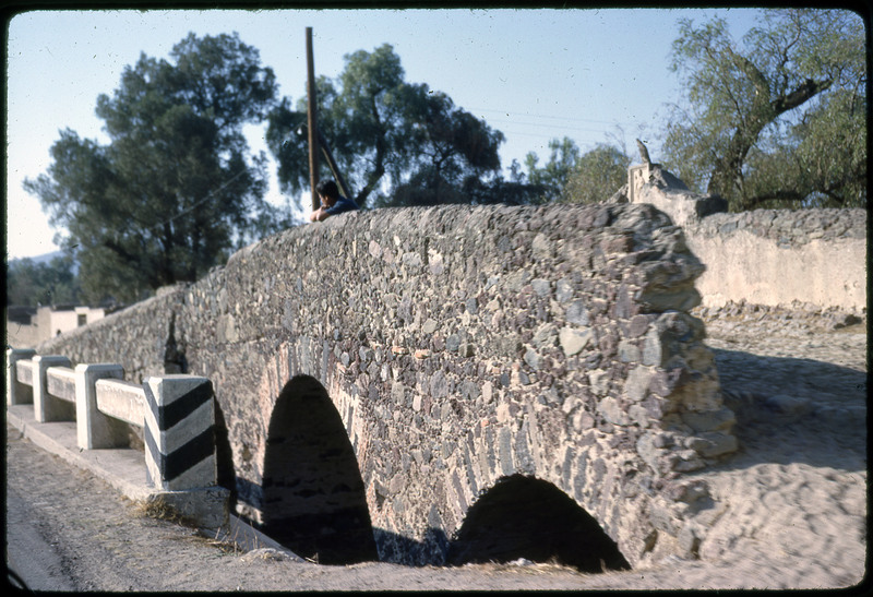 A photographic slide of a crowded outdoor marketplace.