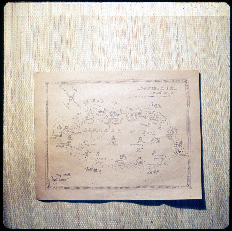 A photographic slide of a hand drawn map of Isla de Cozumel. The map includes many landmarks and is dated 1961.