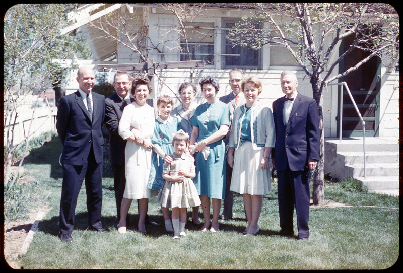 A photographic slide of Donald and Evelyn Crabtree and their family posing in front of a house.