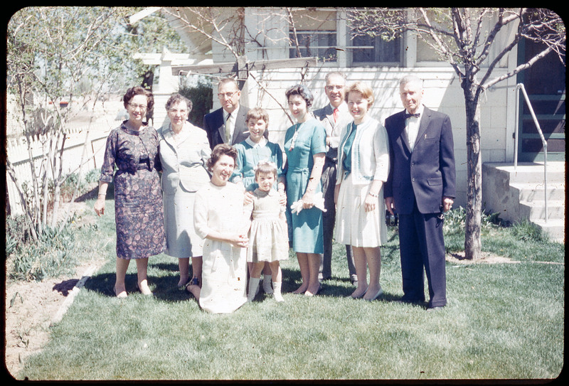 A photographic slide of Evelyn Crabtree and her family standing outside a house. The same people are in CE_B81_F5-Item35 but Donald Crabtree is not in this photo.