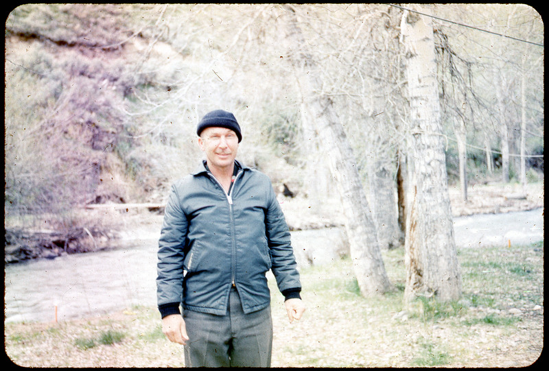 A photographic slide of Donald Crabtree standing in front of some trees on a lawn.