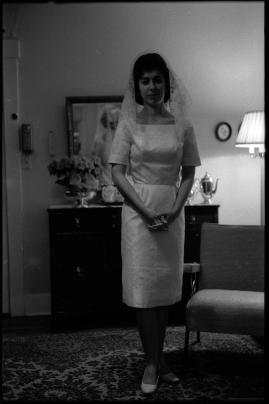 A photo of a woman wearing a wedding dress and posing for the camera. Associated with item numbers: ce_b83_f1-item1-017 through ce_b83_f1-item1-036.