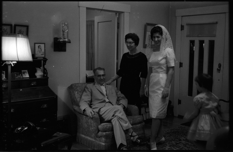 A photo of three people, including a woman wearing a wedding dress, posing for the camera. Associated with item numbers: ce_b83_f1-item1-017 through ce_b83_f1-item1-036.