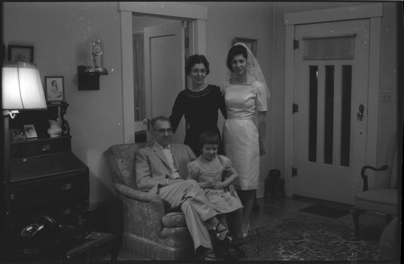 A photo of four people, including a woman wearing a wedding dress and a child, posing for the camera. Associated with item numbers: ce_b83_f1-item1-017 through ce_b83_f1-item1-036.