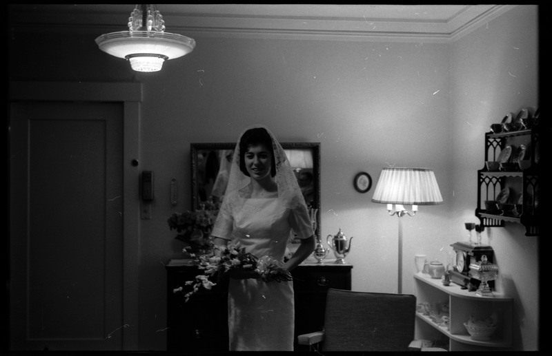A photo of a woman wearing a wedding dress, holding a bouquet of flowers, and smiling for the camera. Associated with item numbers: ce_b83_f1-item1-017 through ce_b83_f1-item1-036.