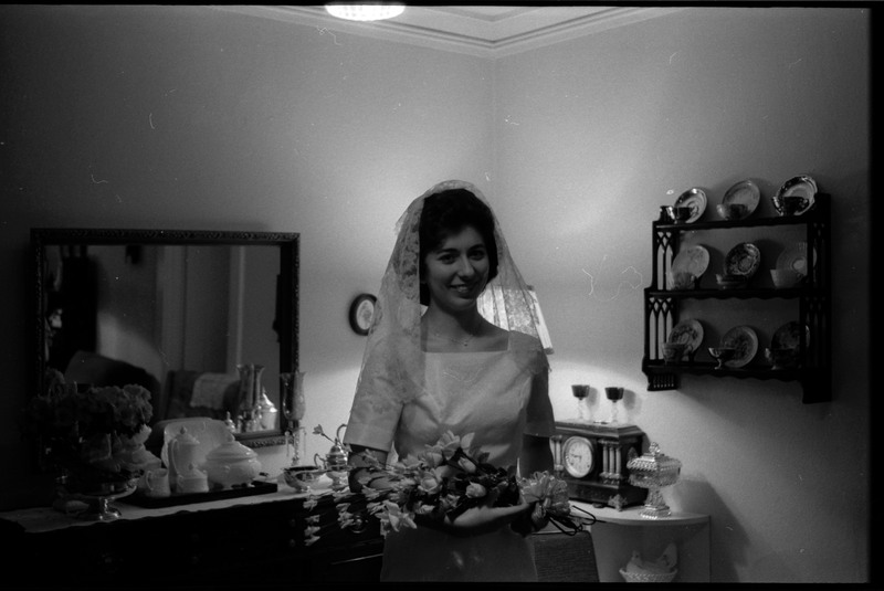 A photo of a woman wearing a wedding dress, holding a bouquet of flowers, and smiling for the camera. Associated with item numbers: ce_b83_f1-item1-017 through ce_b83_f1-item1-036.