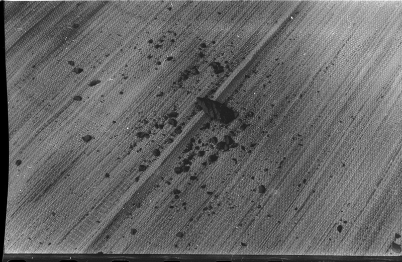 A photo of a flintknapped piece and debitage laying on a rug. Associated with item numbers: ce_b83_f2-item1-004 through ce_b83_f2-item1-024.