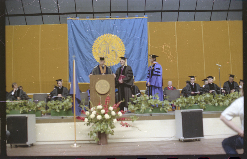 A photo of a group of people, including Donald Crabtree, onstage at a graduation ceremony at the University of Idaho.