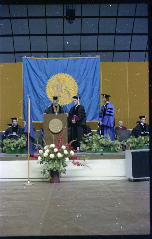 A photo of a group of people, including Donald Crabtree, onstage at a graduation ceremony at the University of Idaho.