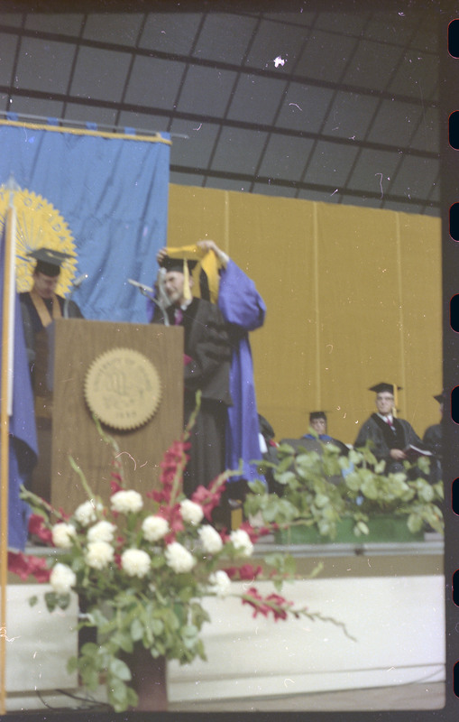 A photo of a group of people, including Donald Crabtree, onstage at a graduation ceremony at the University of Idaho.